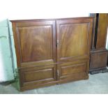 A mahogany cabinet having twin doors opening to reveal twelve slides within,