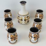 A c1960s Monastery Rye Cinque Ports Pottery carafe and six goblets.