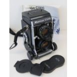 A Mamiya CV330 twin lens reflex camera, with instructions.