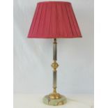 A smart onyx and gilt brass table lamp wired for electricity, complete with crimson satin shade.