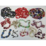 A quantity of assorted vintage glass bead necklaces including a hand painted example, faux pearls,