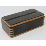 A 1930s Art Deco style ebony and boxwood table cigarette dispenser, with two chambers,