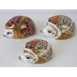 Three Royal Crown Derby hedgehog paperweights; Collectors Guild 'Orchard Hedgehog' 9cm wide,