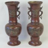 A pair of 19th century Oriental export bronzed brass relief vases, one handle deficient.