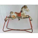 A 1960s Mobo Prairie King tin plate rocking horse on sprung metal frame.