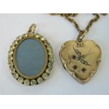 A gold plated locket in the form of a heart having white and red stone set swallow and branch