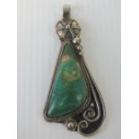 A hand made pendant having triangular green agate in floral white metal setting, 7cm in length.