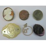 Two lava cameos in white metal brooch frames, together with a mother of pearl cameo brooch,