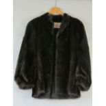 A fine quality vintage dark fur short coat having bell sleeves and bearing label for Dominion Furs,