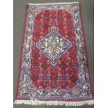 A small Hamadan bordered rug with central medallion, 125cm x 75cm.