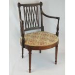 A 19th century mahogany single salon chair raised over turned legs.