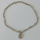 A heavy HM silver fancy link chain having T-bar clasp and white stone encrusted heart shaped