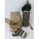 A German cylindrical gas mask cannister, together with a British WWII childs gas mask,