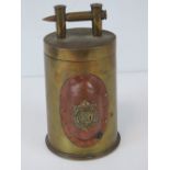 A trench Art shell case lidded pot having Royal Army Services Corps and Canadian Military badges