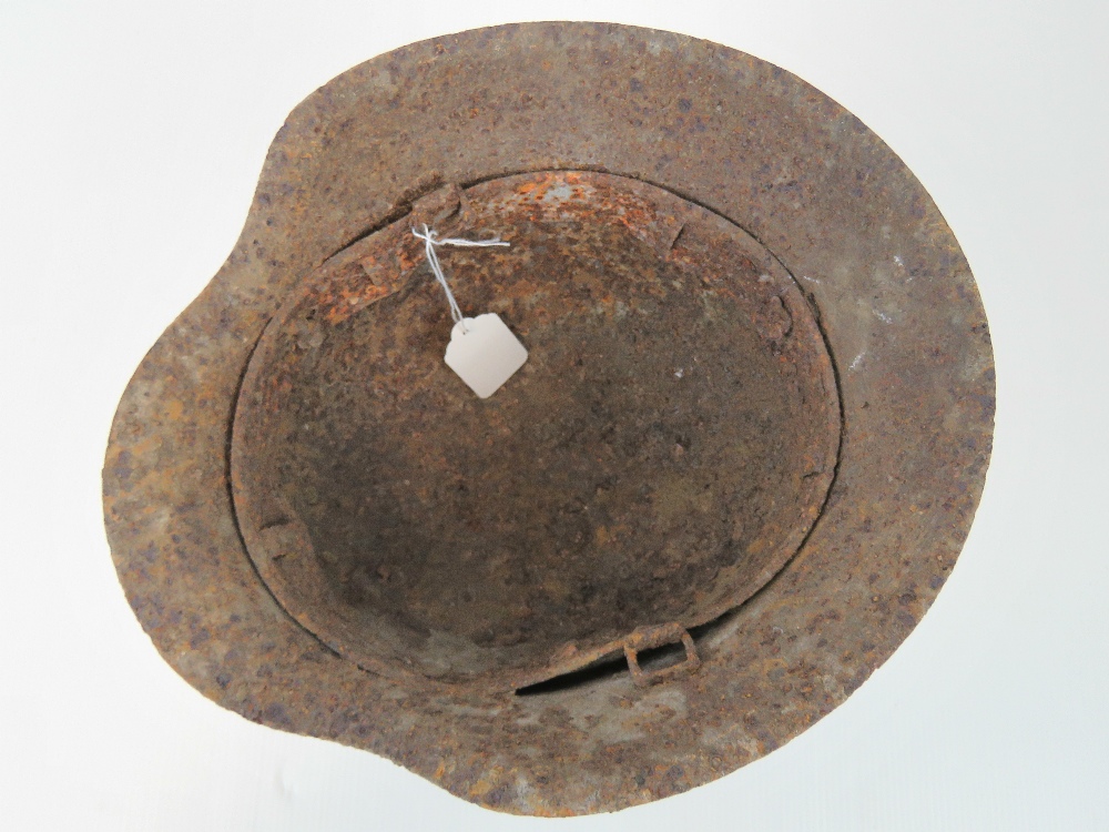 A WWII German helmet in relic condition. - Image 2 of 2