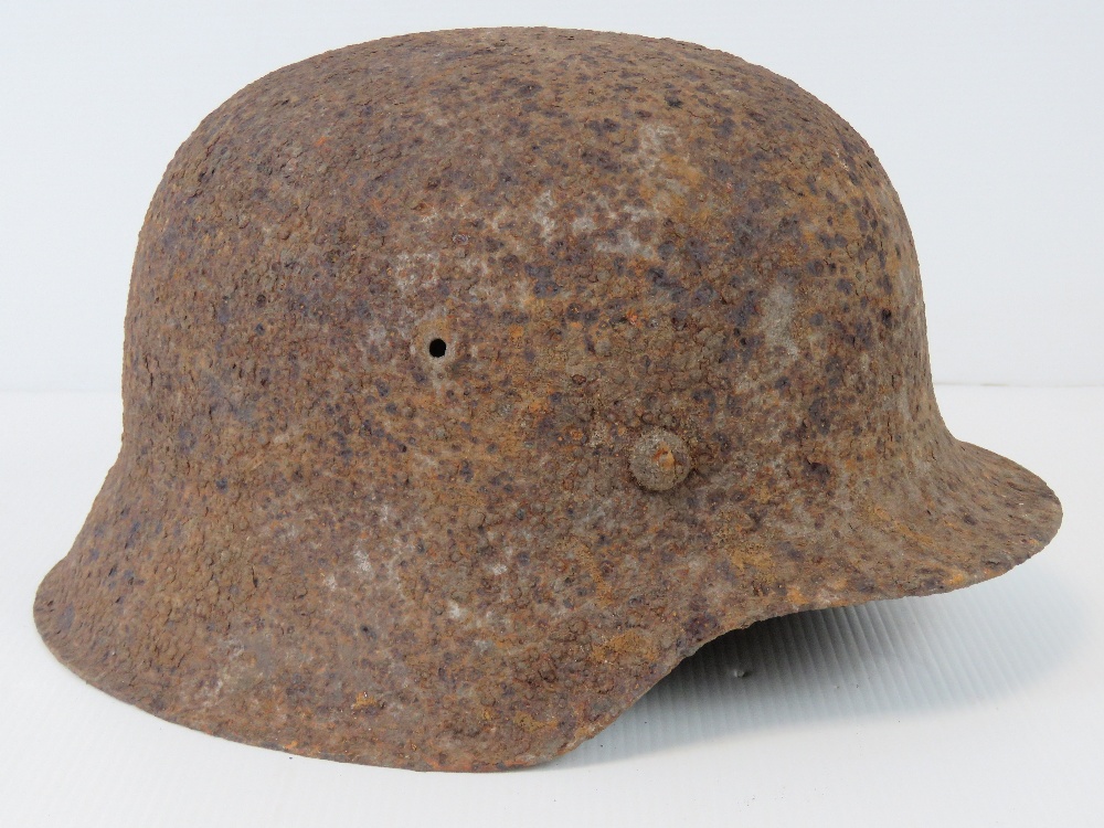 A WWII German helmet in relic condition.