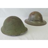 Two original WWI British helmets, one wi