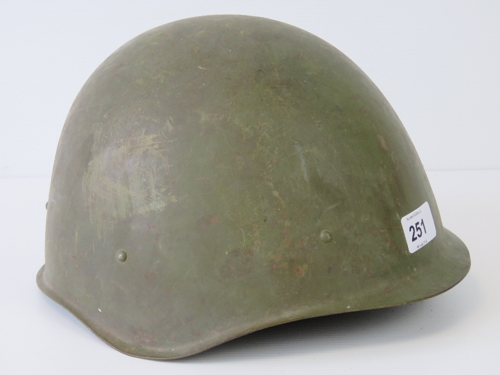 A c1950s Russian helmet with chin strap