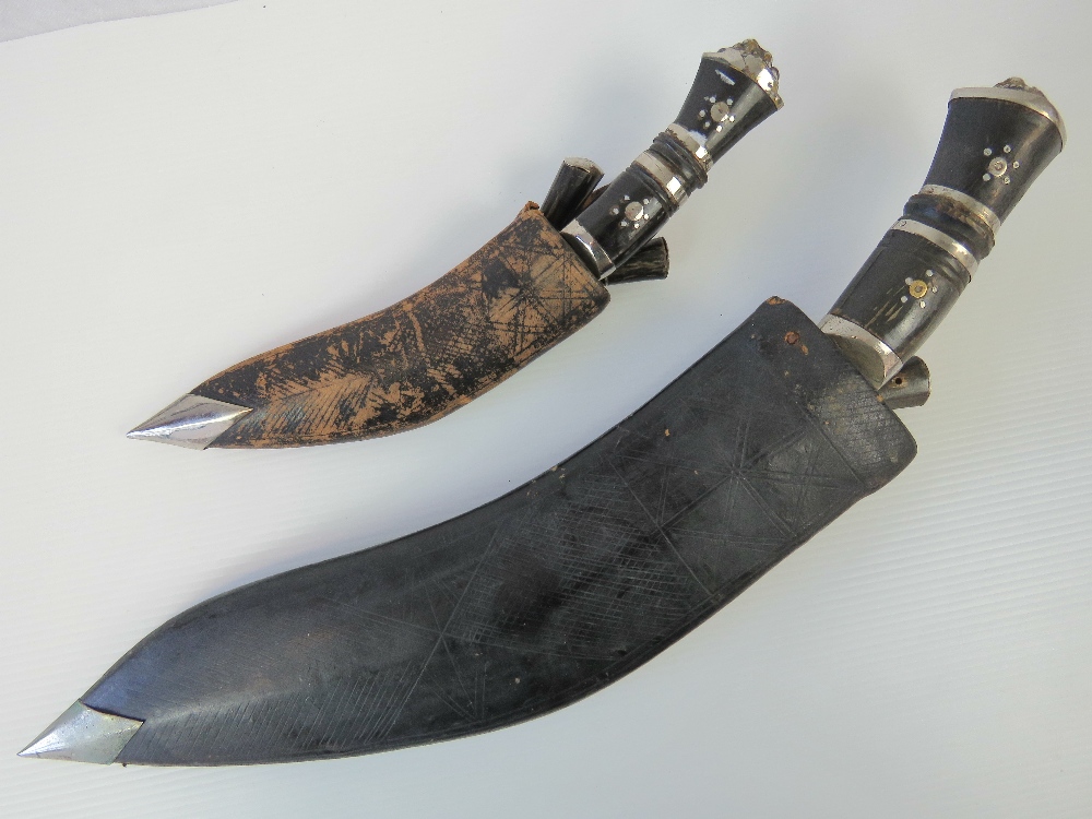 Two Kukri knives with leather sheaths, o