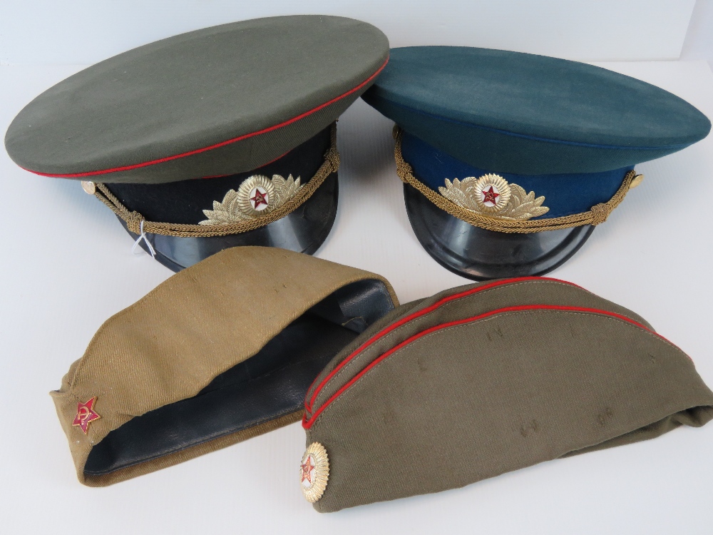 Two Russian military peaked caps togethe