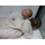 A LARGE BLACK DOLL, THE HEAD STAMPED H.W.6 TOGETHER WITH AN ARMAND MARSEILLE BISQUE HEAD DOLL 351 /3