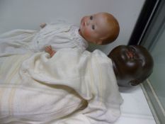 A LARGE BLACK DOLL, THE HEAD STAMPED H.W.6 TOGETHER WITH AN ARMAND MARSEILLE BISQUE HEAD DOLL 351 /3