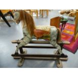 A VINTAGE HAND PAINTED ROCKING HORSE ON TRESTLE BASE.