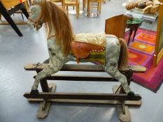 A VINTAGE HAND PAINTED ROCKING HORSE ON TRESTLE BASE.