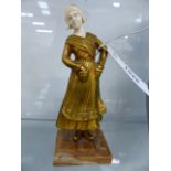 AN EARLY 20th.C.GILT BRONZE AND CARVED IVORY FIGURE OF A DUTCH GIRL ON A STEPPED MARBLE BASE.