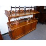 AN EARLY VICTORIAN OAK BUFFET WITH THREE PANELLED DOORS TO THE BASE. W.142cms.