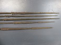 A GROUP OF FIVE ANTIQUE TRIBAL FISHING SPEARS WITH CARVED DECORATION, PROBABLY OCEANIC.