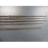 A GROUP OF FIVE ANTIQUE TRIBAL FISHING SPEARS WITH CARVED DECORATION, PROBABLY OCEANIC.