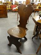 A 19th.C.OAK HALL CHAIR ON SHAPED SUPPORTS.