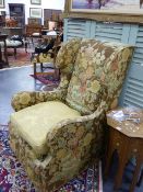 AN ANTIQUE GEORGIAN STYLE WING BACK ARMCHAIR.