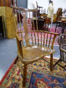 AN EARLY ASH AND ELM STICK BACK ARMCHAIR WITH SADDLE SEAT AND SHAPED CREST RAIL.