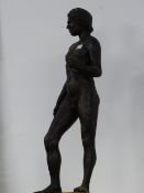 20th.C.ENGLISH SCHOOL. A STANDING MALE NUDE IN PATINATED RESIN ON WOOD BASE. OVERALL H.71cms.