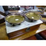 A SET OF SCALES WITH MAHOGANY INLAID BODY, MARBLE SURFACE AND TWO BRASS PANS.