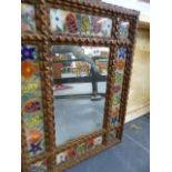 AN UNUSUAL FOLK ART EGLOMISE FRAMED MIRROR.