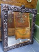 A VICTORIAN CARVED OAK MIRROR WITH HERALDIC CREST, THE FRAME DECORATED WITH OAK LEAVES AND ACORNS.