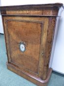 A 19th.C.BURR WALNUT AND INLAID SIDE CABINET WITH BRASS MOUNTS AND INSET PORCELAIN PLAQUE. W.83 x