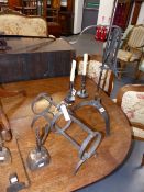 AN EARLY WROUGHT IRON ADJUSTABLE LARKSPIT, TWO RUSH NIPS, A PAIR OF CANDLESTICKS,ETC.