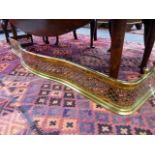 A LARGE 19th.C.PIERCED BRASS SERPENTINE FIRE FENDER.