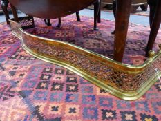 A LARGE 19th.C.PIERCED BRASS SERPENTINE FIRE FENDER.