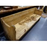 AN ANTIQUE PINE RUSTIC HALL BENCH WITH SHAPED ARMS. W.198cms.
