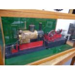 A LARGE SCRATCH BUILT STEAM BOILER AND MILL ENGINE IN A GLAZED DISPLAY CASE.