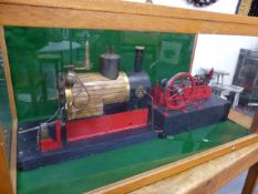 A LARGE SCRATCH BUILT STEAM BOILER AND MILL ENGINE IN A GLAZED DISPLAY CASE.