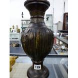 AN ORIENTAL CHAMPLEVE BRONZE BALUSTER VASE WITH IRIS DECORATION. H.31cms.