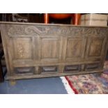 AN 18th.C.OAK MULE CHEST WITH DRAGON CARVED FRIEZE. W.152cms.