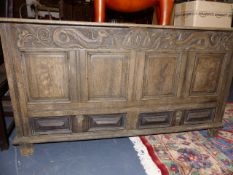 AN 18th.C.OAK MULE CHEST WITH DRAGON CARVED FRIEZE. W.152cms.