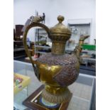 A LARGE ANTIQUE TIBETAN BRASS AND COPPER LIDDED KETTLE.